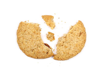 Round cracked wholewheat biscuit, cookie with raisins and crumbs isolated on white background