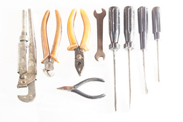 old metal tools with traces of rust on a white background top view