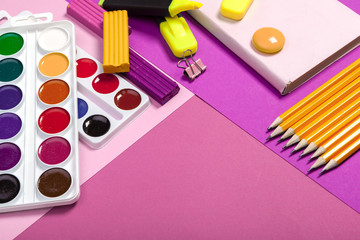 school supplies at abstract colorful background texture