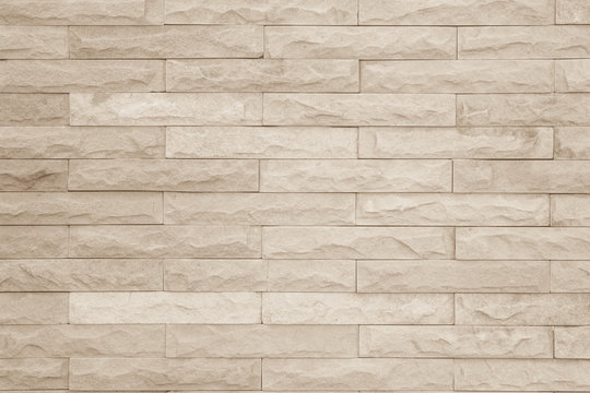 Seamless cream pattern of decorative brick sandstone wall surface with concrete of modern style design decorative uneven have cracked realmasonry wall of multicolored stones or blocks with cement.
