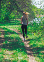 Young girl running at the forest happy