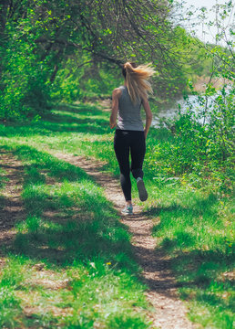 Young girl running at the forest happy