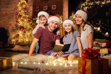 Happy family in a room with a Christmas tree. Marry christmas at home.