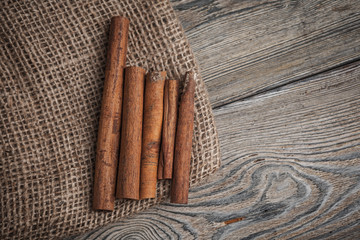 Cinnamon sticks on wooden background.