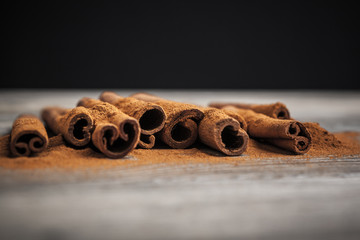 Cinnamon sticks on wooden background.