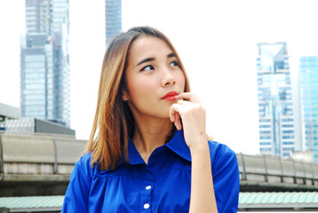 Beautiful Asia girl smile portrait on walking street and building background.