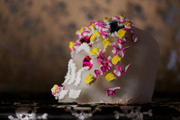 A Calavera is a representation of a human skull and made from either sugar and are decorated with colored foil and icing which is used in the Mexican celebration of the Day of the Dead.