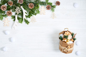 Festive composition of Christmas decorations on white wooden background.