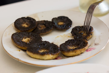 Grilled mushrooms plate. Fork taking vegetarian snack