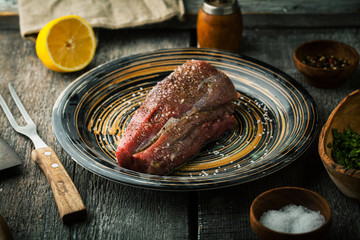 Raw beef tenderloin with salt  and seasonings
