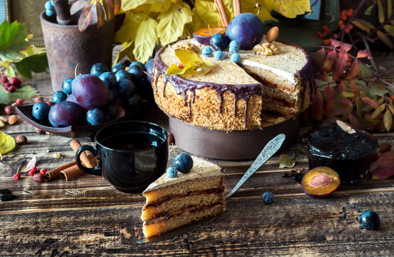 Autumn composition with a slice of cream cake with chocolate and nuts, rustic