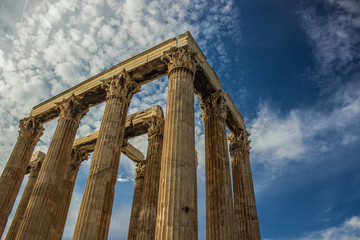 ancient marble column of old temple in outdoor museum place on blue sky background 