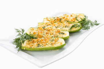 Zucchini stuffed with cheese on a white plate