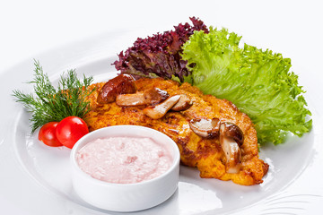 Pancakes with pumpkin and porcini mushrooms on a white plate