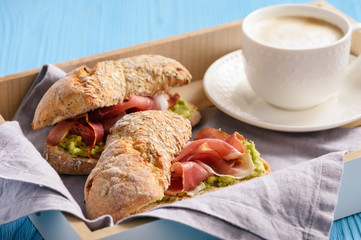 Sandwiches with ham and avocade spread.