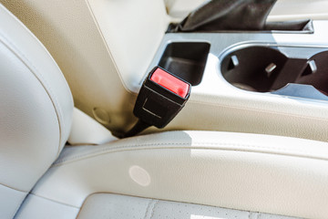 cropped image of leather car seats and retractable platform of seatbelt
