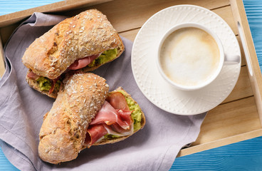 Sandwiches with ham and avocade spread.