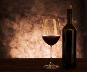 Glass with Red Wine on wooden background