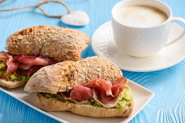 Sandwiches with ham and avocade spread.