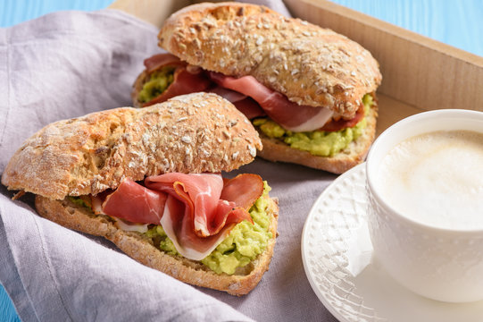 Sandwiches with ham and avocade spread.