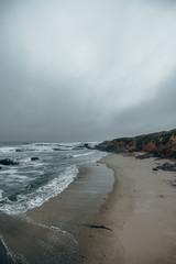 Ocean waves, coastline view in California. Sand beach