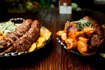 Lula kebab with vegetables. Minced mutton chop on the big steel plate