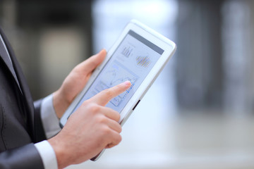 close up.businessman working on a digital tablet with financial