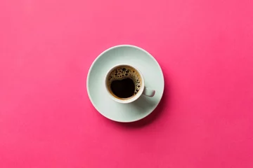 Zelfklevend Fotobehang Blue cup of coffee on a colorful pink background. top view with copy space. morning concept © sosiukin