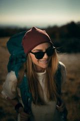 young woman hiking on the beautiful sunny autumn day