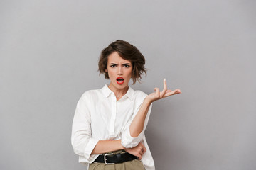 Portrait of a cofused young woman dressed in white shirt