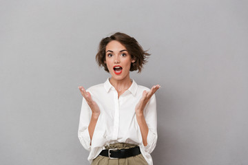 Portrait of a cheerful young woman dressed in white shirt