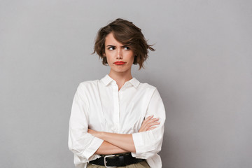 Portrait of an upset young woman dressed in white shirt