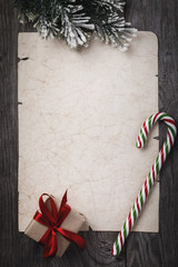 Letter to Santa Claus. Christmas gift and old sheet of paper with copy space on wooden table