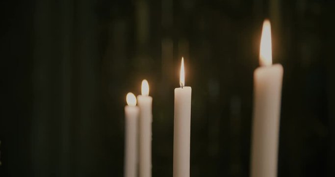 Four wax candles in the church.
