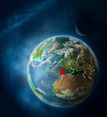 Obraz na płótnie Canvas Spain from space on Earth surrounded by space with Moon and Milky Way. Detailed planet surface with city lights and clouds.