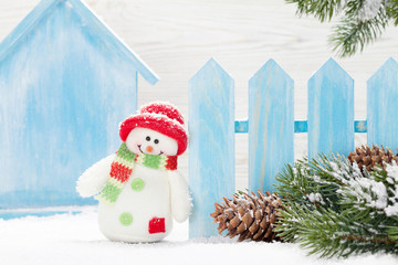 Christmas snowman toy and fir tree branch