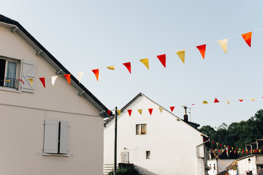 Flags hanging amidst houses
