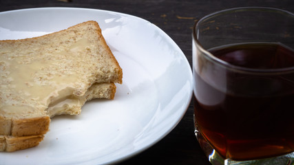 Black coffee With bread put milk, Concept Simple breakfast in the morning.