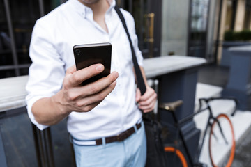 Businessman dressed in shirt standing outdoors