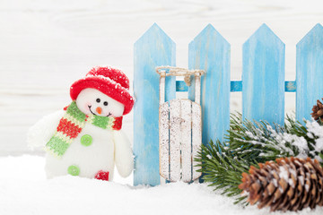 Christmas snowman and sledge toys and fir tree branch