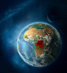 Dem Rep of Congo from space on Earth surrounded by space with Moon and Milky Way. Detailed planet surface with city lights and clouds.