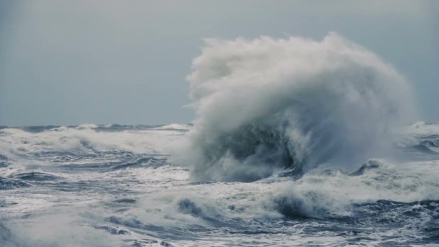 High wave breaking on the rocks of the coastline. Extremely Big Wave crushing coast , Large Ocean Beautiful Wave. Super Slow Motion.