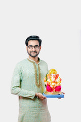 Young Indian man with Lord Ganesha , Celebrating Ganesh festival