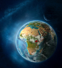 Uganda from space on Earth surrounded by space with Moon and Milky Way. Detailed planet surface with city lights and clouds.