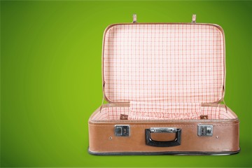 Empty Vintage Suitcase open isolated on green background