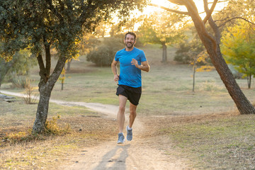 Athletic young man running in the nature at sunset in autumn in fitness Healthy lifestyle