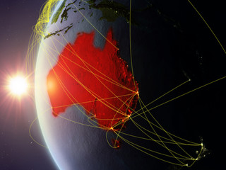 Australia from space on model of Earth during sunset with international network. Concept of digital communication or travel.