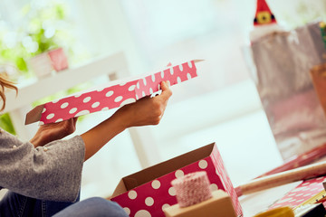 Woman preparing presents for family and friends for Christmas and New Year. Holiday concept.