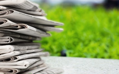 Pile of newspapers on white background