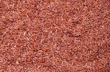 Whole grain red rice. Food background.